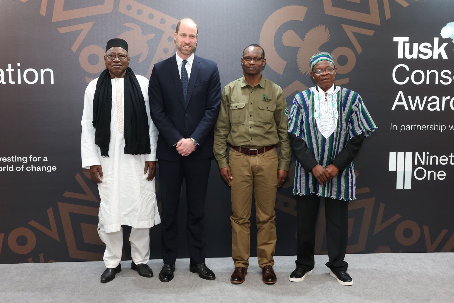 Claver Ntoyinkima poses for a photo with Prince William and two other finalists at the awarding ceremony in London.