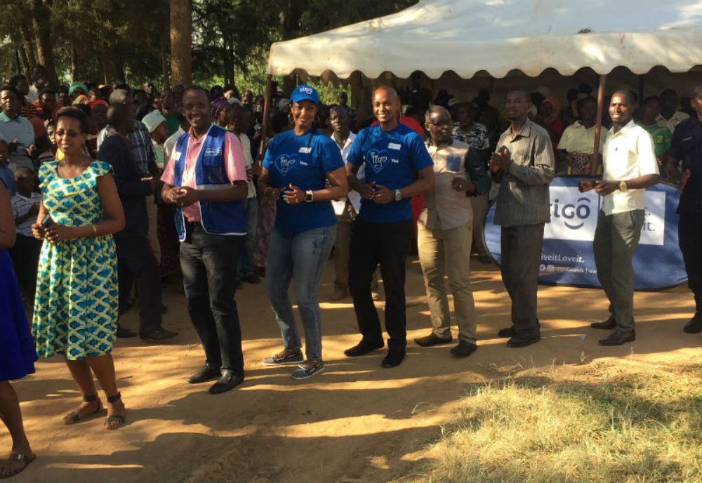 Tigo staff join local residents in a dance