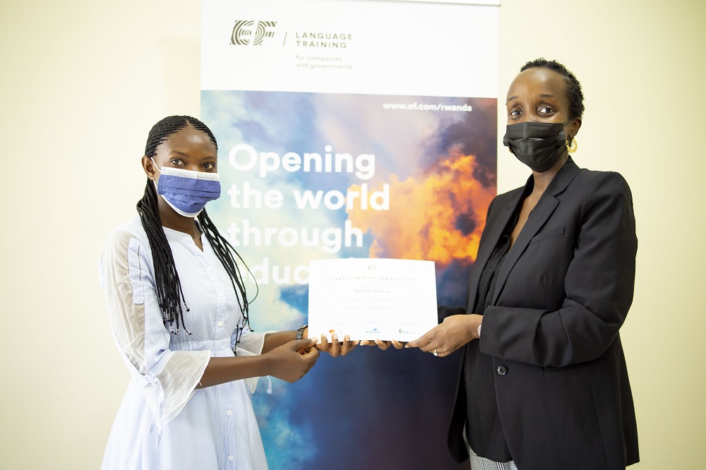 The Acting Country Manager at EF Education First Rwanda, Oriane Ruzibiza handing over certificate to one of graduates, Rachel.   