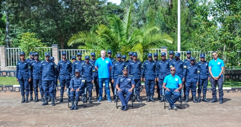 Graduates in a group photo with superiors and trainers. 