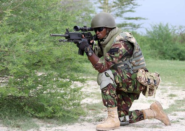A Kenya Defence Forces, under Africa Union Mission in Somalia (Amisom), soldier takes position during a patrol at Afmadow town on November 22, 2015. Currently Kenya, Uganda, Burundi, Djibouti and Ethiopia have their forces under Amisom.