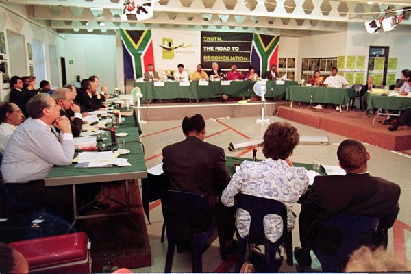 This file photo taken on November 24, 1997 shows Winnie Madikizela-Mandela (centre from behind) flanked by her legal representatives attending her Truth and Reconciliation Commission (TRC) hearing in Johannesburg.