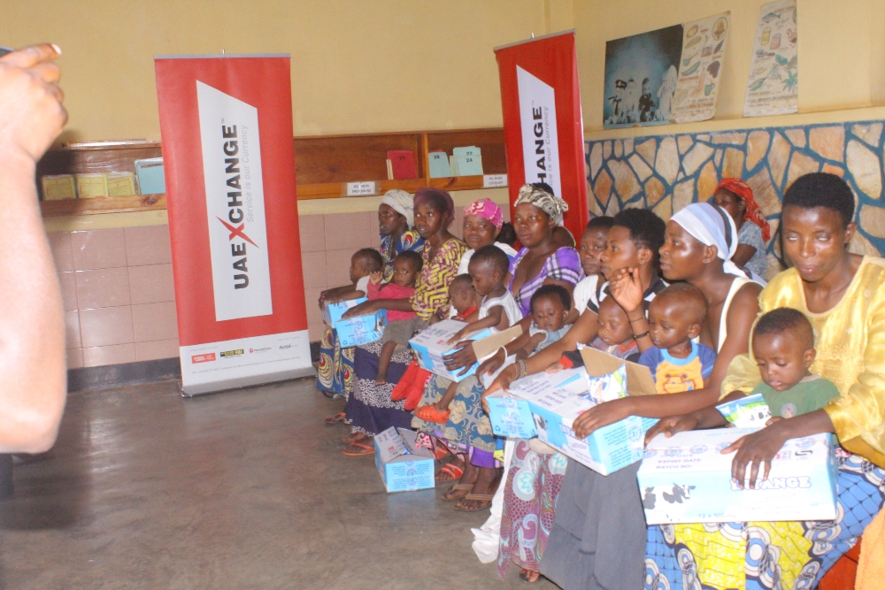 Parents with their children after receiving milk packages