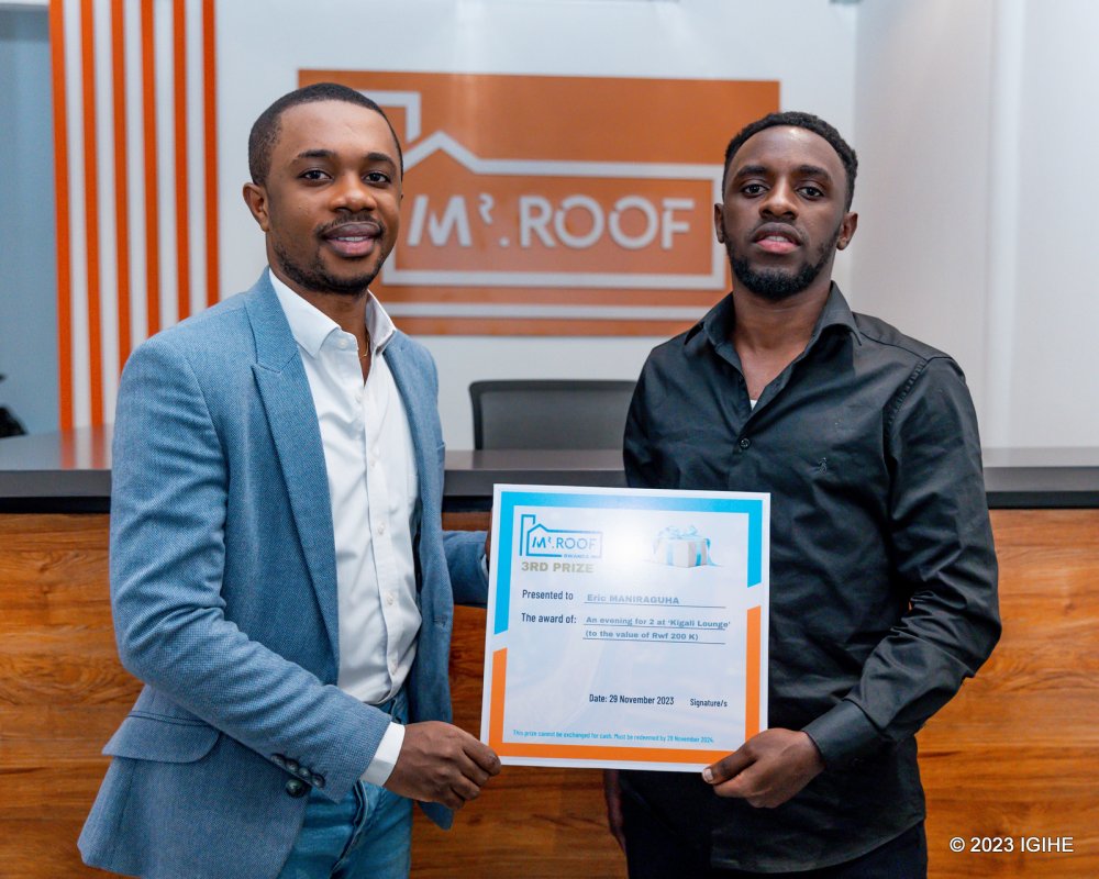 The Manager of Kigali Lounge presenting the prize to Maniraguha Eric.