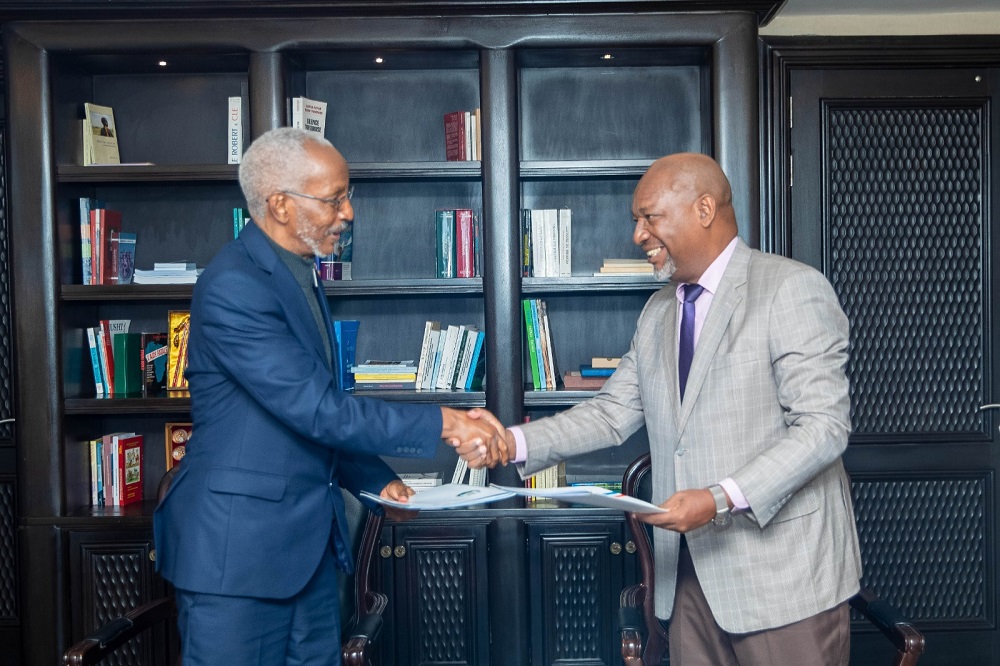 François Ngarambe (left) handing over duties to his successor, Gasamagera. 