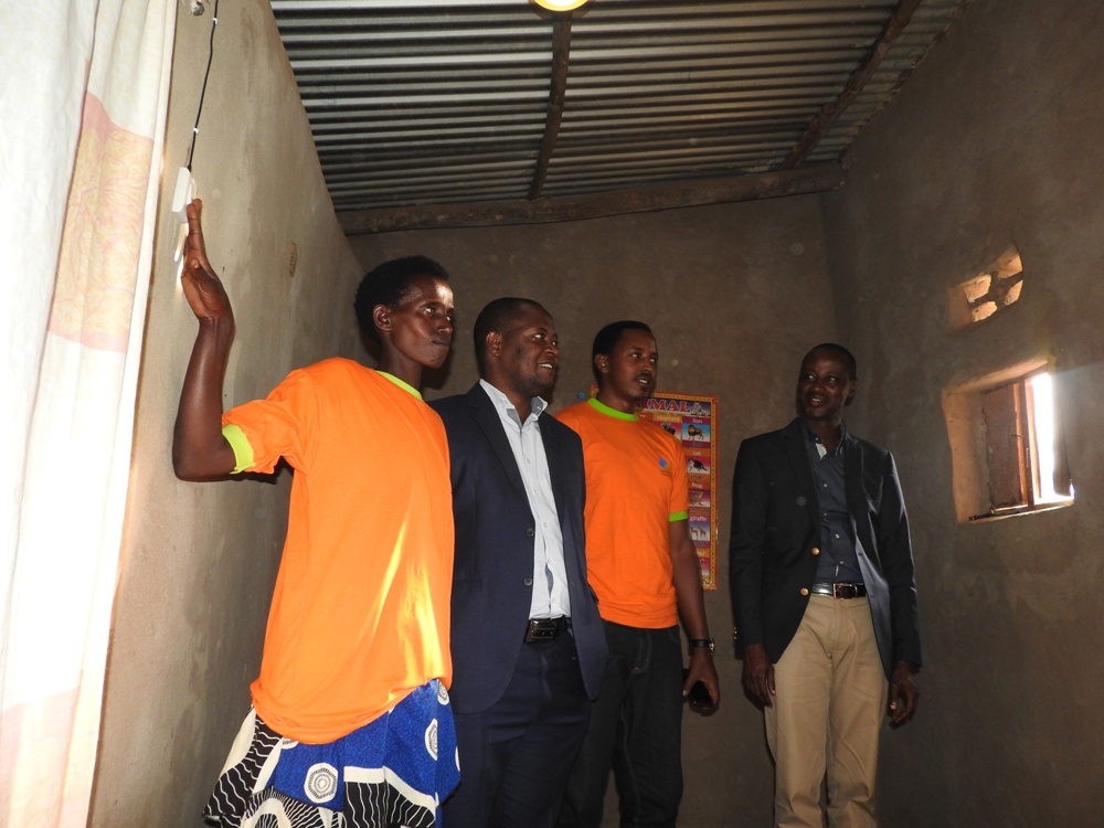Nyagatare resident switches the light during the inauguration solar power facilities.