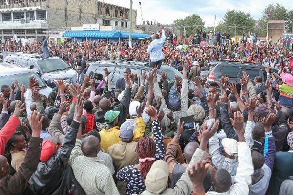 President Uhuru Kenyatta and Deputy President William Ruto acknowledge greetings from residents of Ol-Kalau trading centre, Nyadarua County. The duo will on April 16, 2016 lead the Jubilee troops at Nakuru’s Afraha Stadium to celebrate the collapse of their ICC cases.