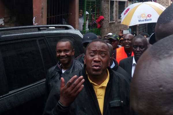 President Uhuru Kenyatta at the scene where a building collapsed in Huruma, Nairobi on April 30, 2016.