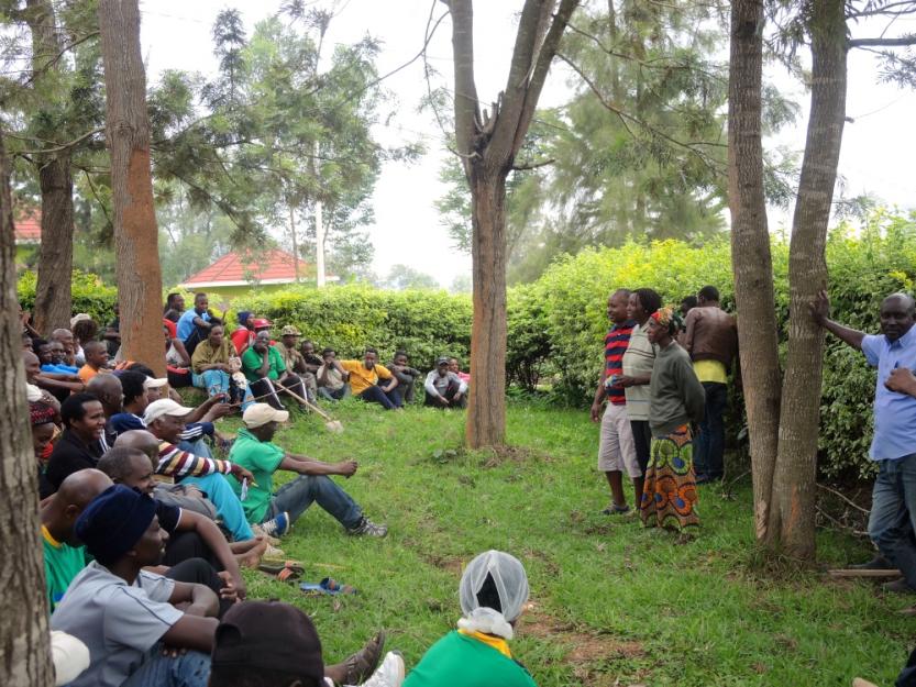 After three hours of weeding and pruning a dirt path, the residents of Kimani Village in Kigali, Rwanda, gathered for an hour-long community meeting. (GSR photo / Melanie Lidman)