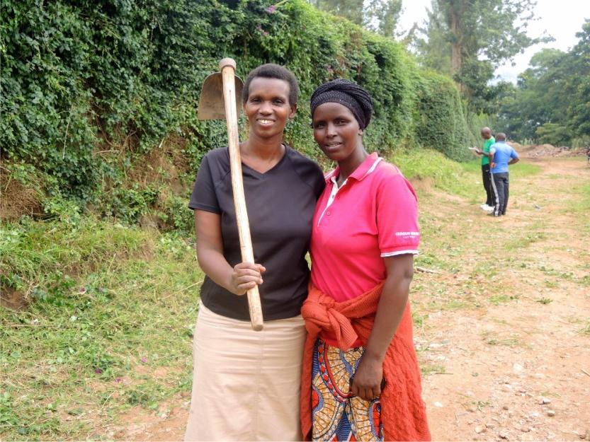 Yvonne Nshuti, left, poses with a neighbor during the monthly Umuganda community service day in Kigali, Rwanda. Neighbors use Umuganda to catch up with people they barely see during the workweek, she said. (GSR photo / Melanie Lidman)