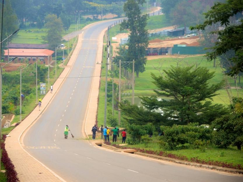 A woman sweeps during Umuganda community service time in February. The streets are completely empty of cars and motorbikes during the four hours of community service and meeting time. (GSR photo / Melanie Lidman)