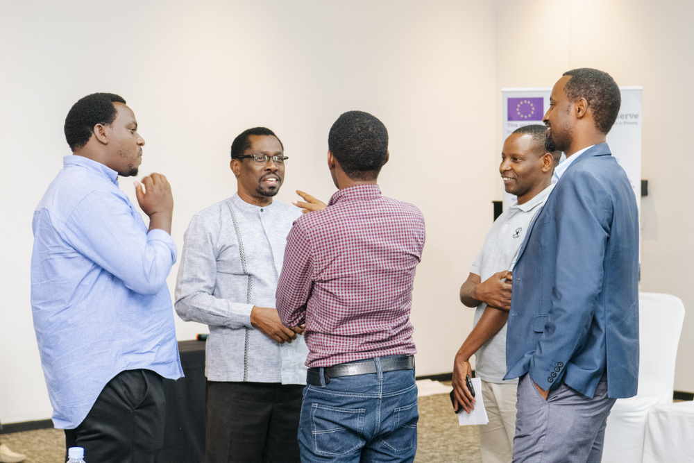 Francis Twagirayesu, Quality Assurance & Regulatory Division Manager at NAEB interacting with coffee value chain players. 