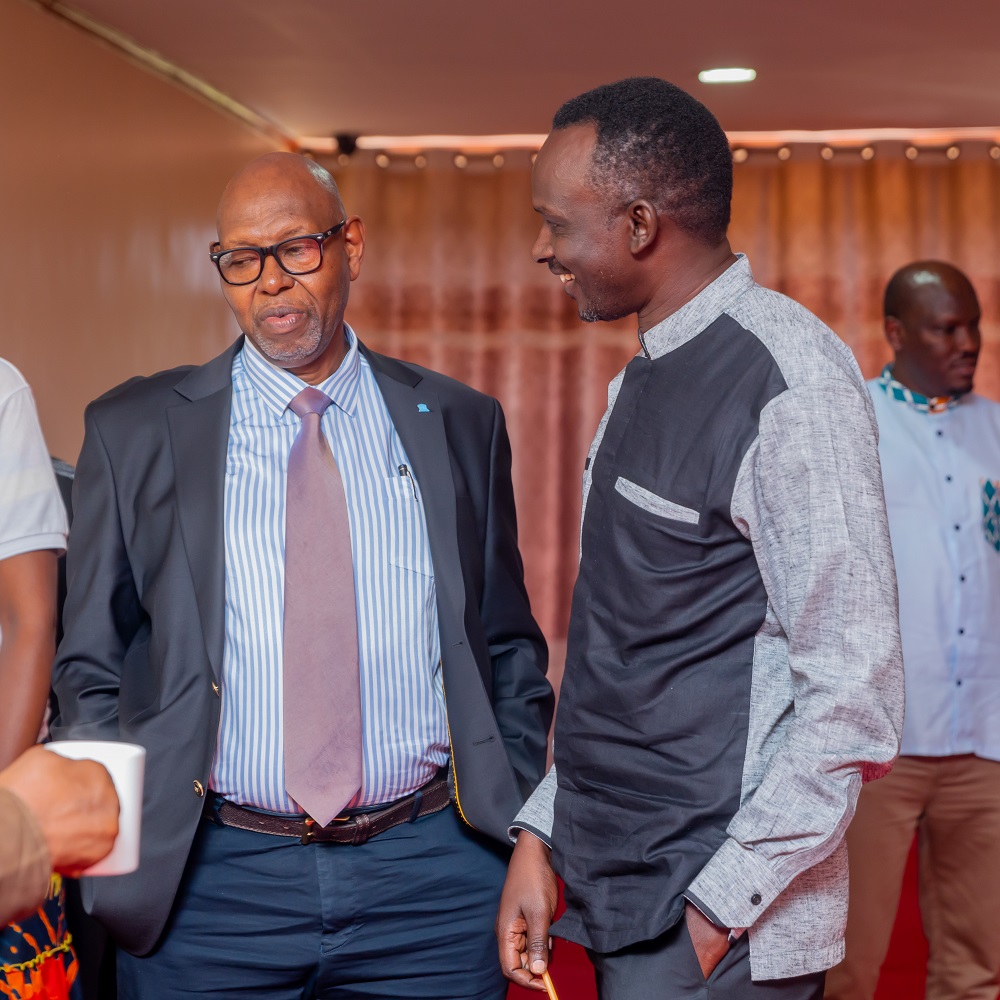 Aha Albert Mutesa chatting with Rugengamanzi Nkubana Felecien  representing REB at the event. 