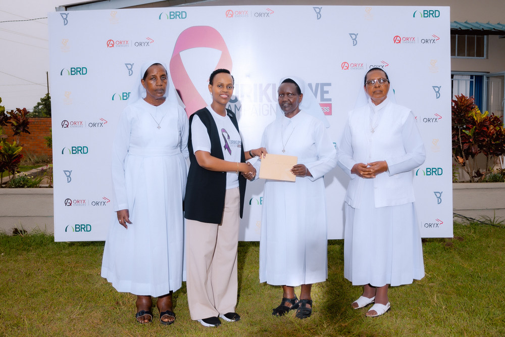 The founder of YB Foundation, Raissa Umutoni handing over the donationn to the management of Bethania Home Care.