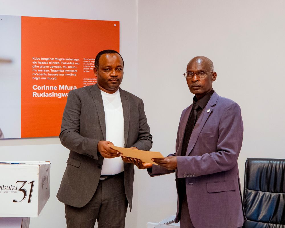 The Chairperson of the Board of LOLC Unguka Finance, Yves Sangano, hands over a donation to the President of Ibuka in Rubavu District to support the preservation of history at the Commune Rouge Memorial.
