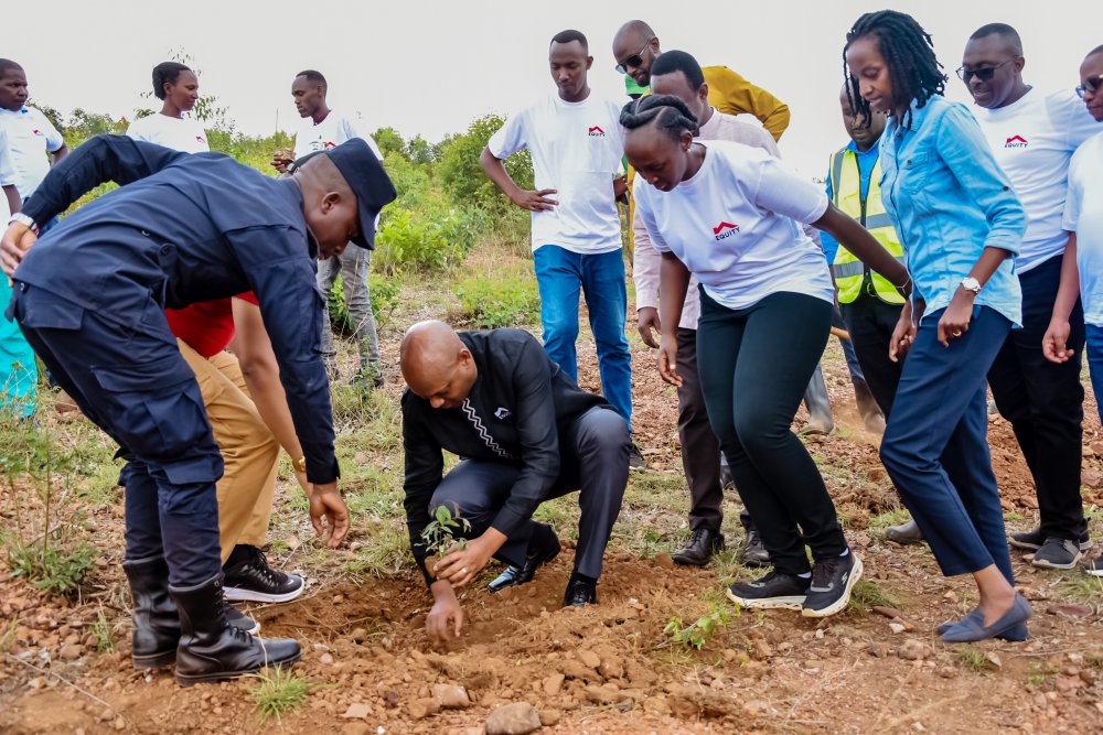 The Managing Director of Equity Bank Rwanda PLC, Hannington Namara planting a tree.