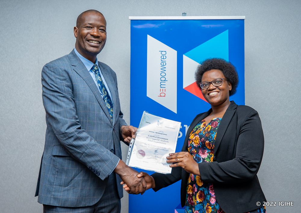 The CEO of KASNEB, Dr. Nicholas Kibiwot Letting awarding a certificate to Nyiratwagirimfura. 