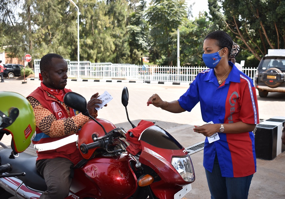 The Vivo Energy Rwanda Managing Director, Sarah Doukouré handing a face-mask to a moto driver