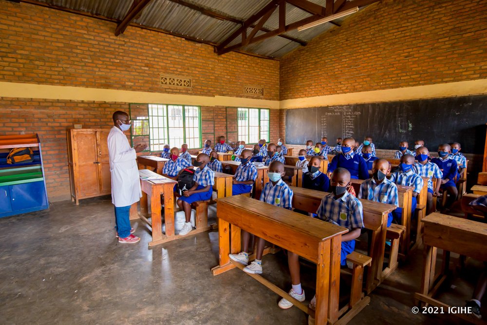 Learners at Groupe Scolaire Remera Catholique with their teacher in class.