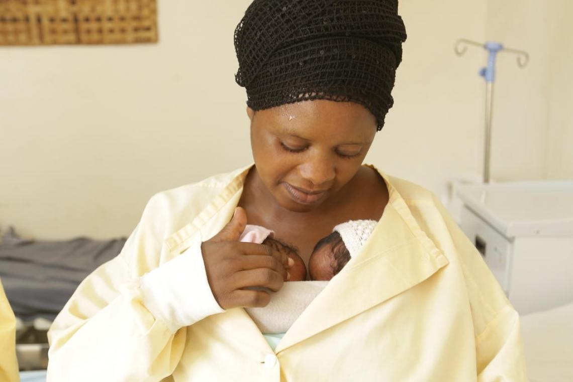 Jemimah holds her twin babies close, using the "Kangaroo Care" technique to help them sleep better and grow faster.
