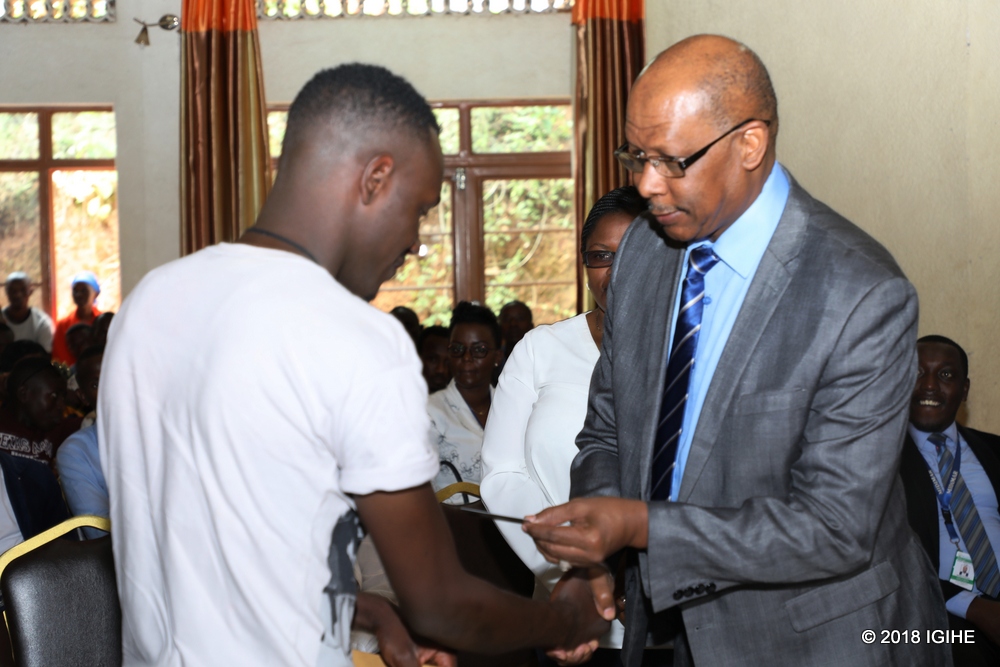UNHCR Representative to Rwanda, Ahmed Baba Fall,handing over the new refugee identity cards (IDs)