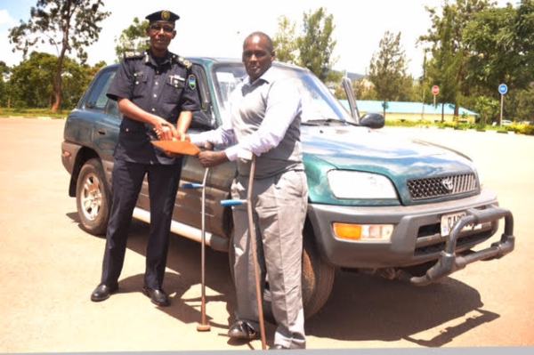 Rwanda National Police handing over the vehicle to its rightful owner