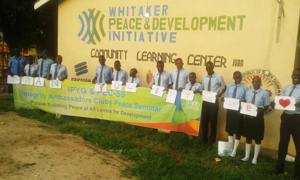 The youth gathered in Juba for peace seminar were smiling holding the banner