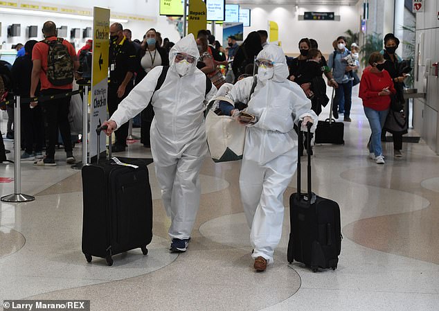 Nearly 6 million Americans traveled by air between Friday and Wednesday. A number that is however less than half that of the same period last year. Pictured, airline passengers seen wearing Hazmat Suits at Fort Lauderdale Hollywood International Airport on Thanksgiving.