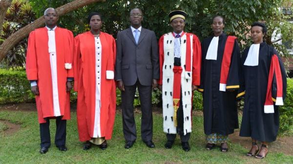 The Prime Minister, Anastase Murekezi pose for a photo with new sworn in prosecutors
