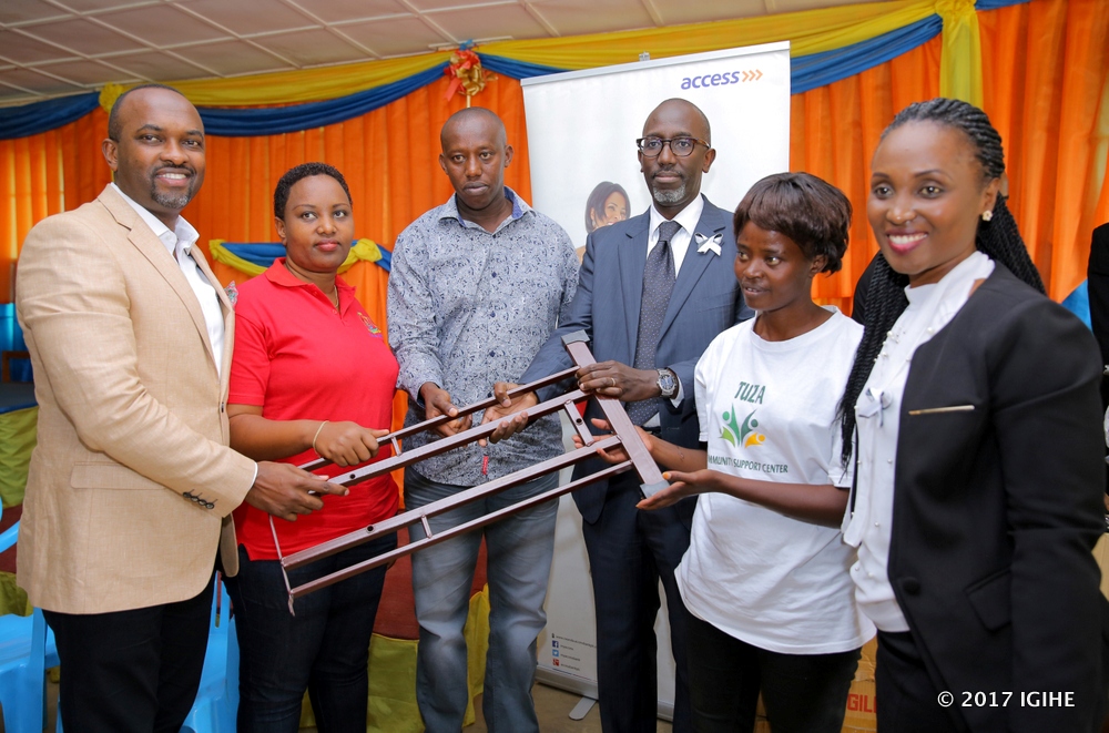 Access bank staff handing donations to beneficiaries