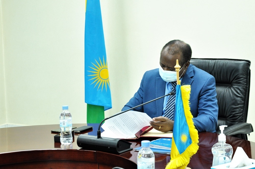 Rwanda's Minister of Finance and Economic Planning, Dr. Uzziel Ndagijimana signing the agreement.  
