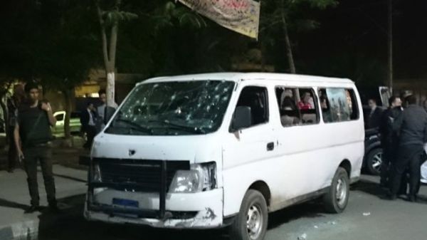 People gather gather around a bullet-ridden police vehicle in Helwan, south of Cairo - 8 May 2016Image copyrightAP Image caption The police van was on patrol in Helwan overnight