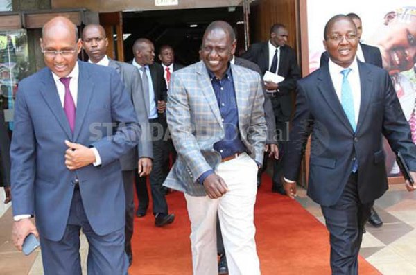 Deputy President William Ruto is escorted by the CS for Industrialization Adan Mohamed and Old Mutual Group CEO Peter 