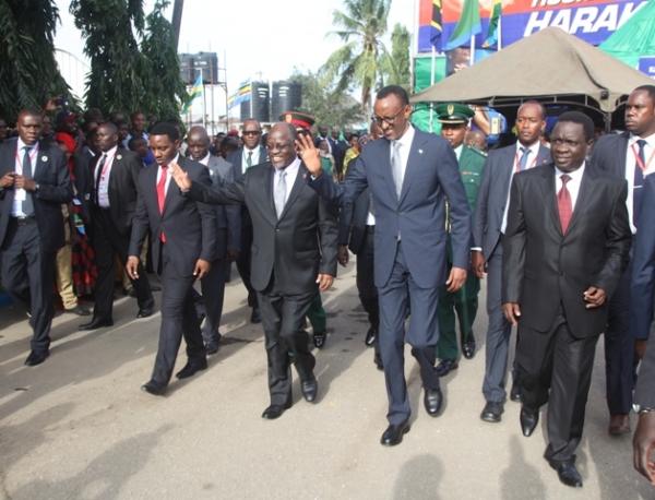  Chief guest for the 40th Dar es Salaam International Trade Fair (DITF), President Paul Kagame of Rwanda and his host, President John Magufuli wave to the crowd after opening the exhibitions at DITF in the city yesterday. They are flanked by the Minister for Industries, Trade and Investment, Mr Charles Mwijage (right) and Dar es Salaam Regional Commissioner, Mr Paul Makonda. 
