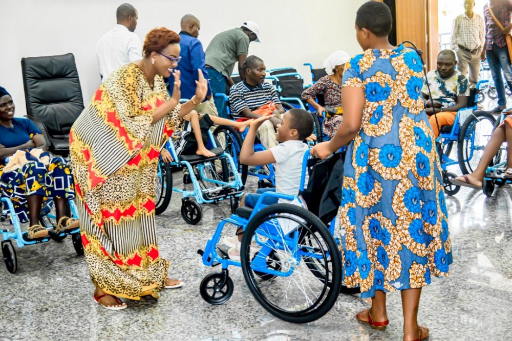 Gahongayire interacting with wheelchair beneficiaries.