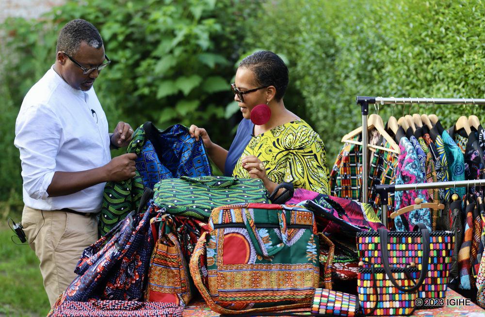 IGIHE journalist looking at Made in Rwanda garments retailed by Sophie Sankoh.