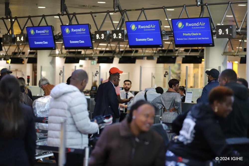 Passengers complete check-in procedures in Brussels before continuing to Paris and then heading to Kigali on their RwandAir flight.