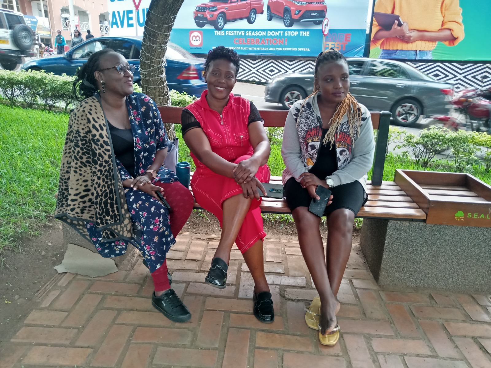 Jeniffer Nankabirwa, the Film Producer (C) enjoys a light moment with some of her team members on a street in Kigali.