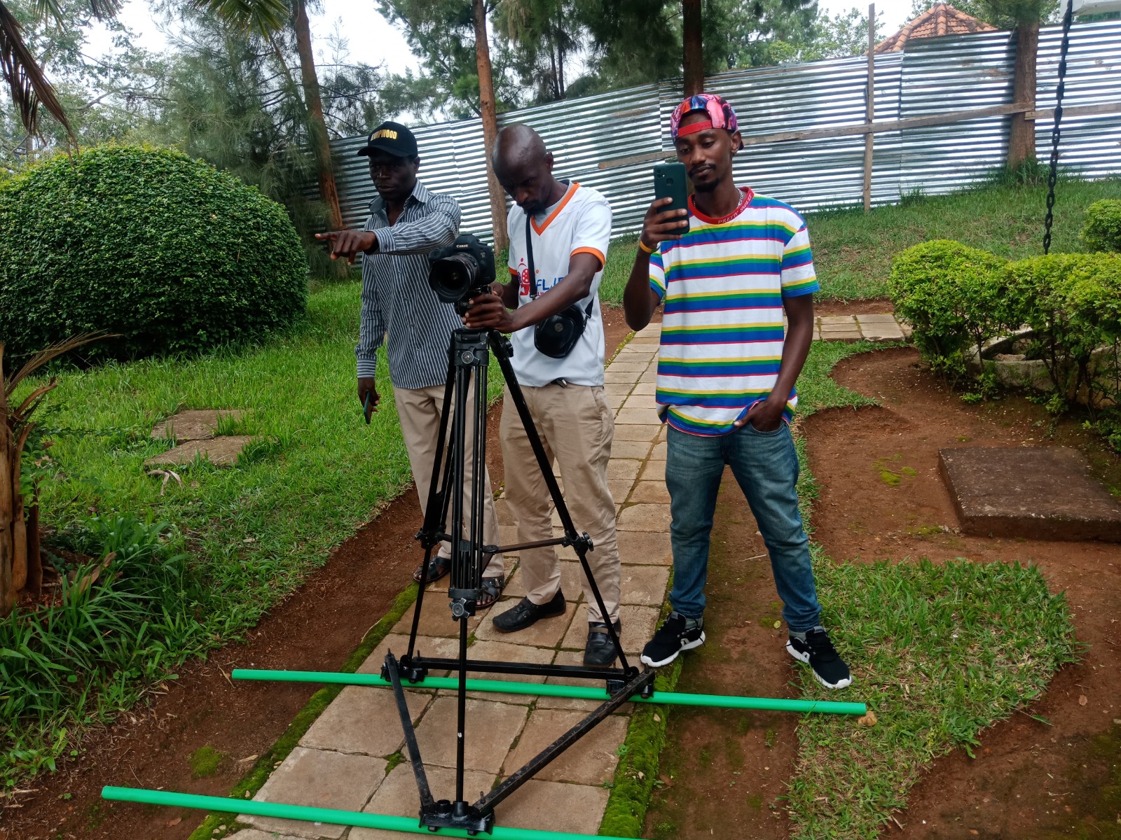 Charles Mugisha (R) from Umurage Art Films with his Ugandan counterparts during a shooting session in Kigali.