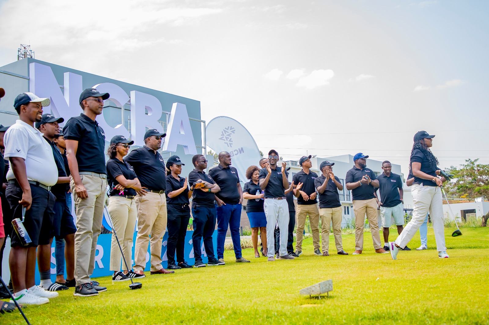 Diana Mukunde, the Head of Corporate Banking at NCBA Rwanda participates in NCBA Rwanda golf series launch as colleges cheer on.