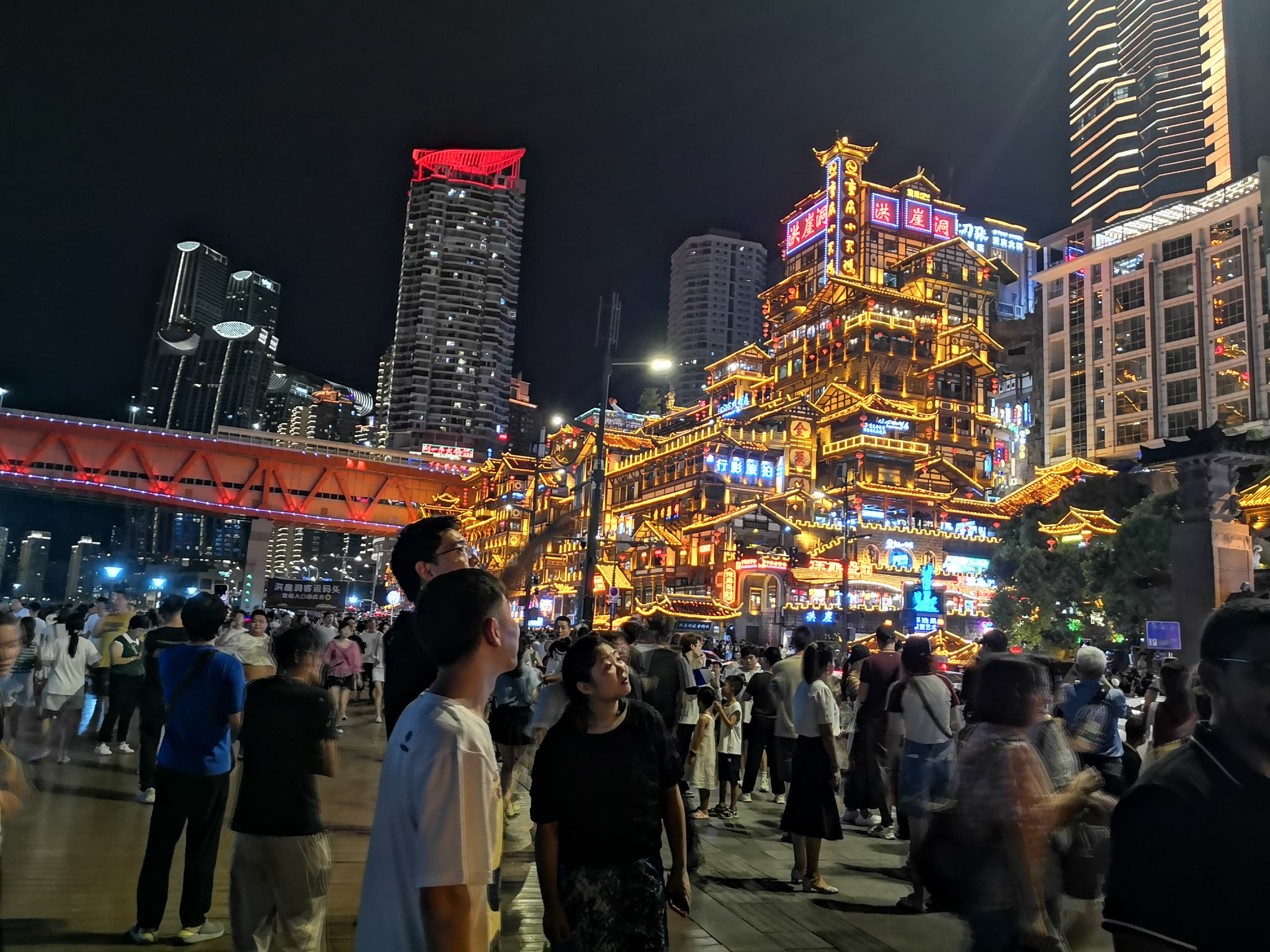 At night, people gather along the Jialing River to enjoy the city's beautiful scenery and glittering lights of the magnificent bridges over the river.