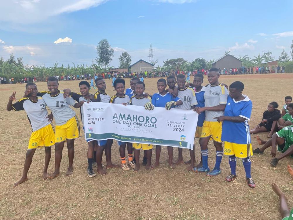 Players posing for a photo at a football pitch in Murambi.