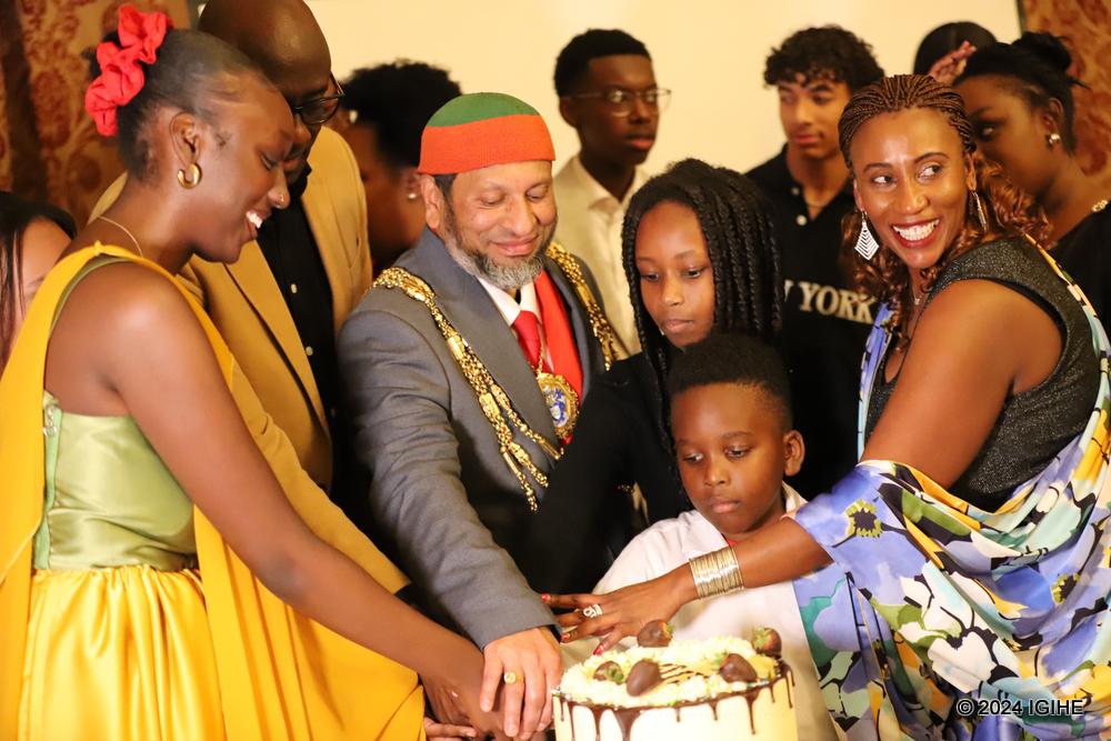 Participants cutting a cake at the event to celebrate unity.