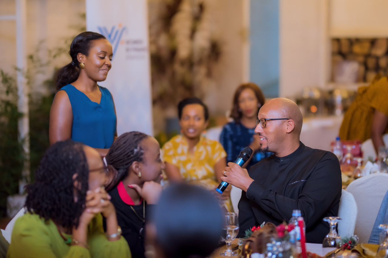 Amanda Musiimire, who served as the MC for the event, engages Tony Francis Ntore, CEO of the Rwanda Bankers Association, during the highly interactive dinner.