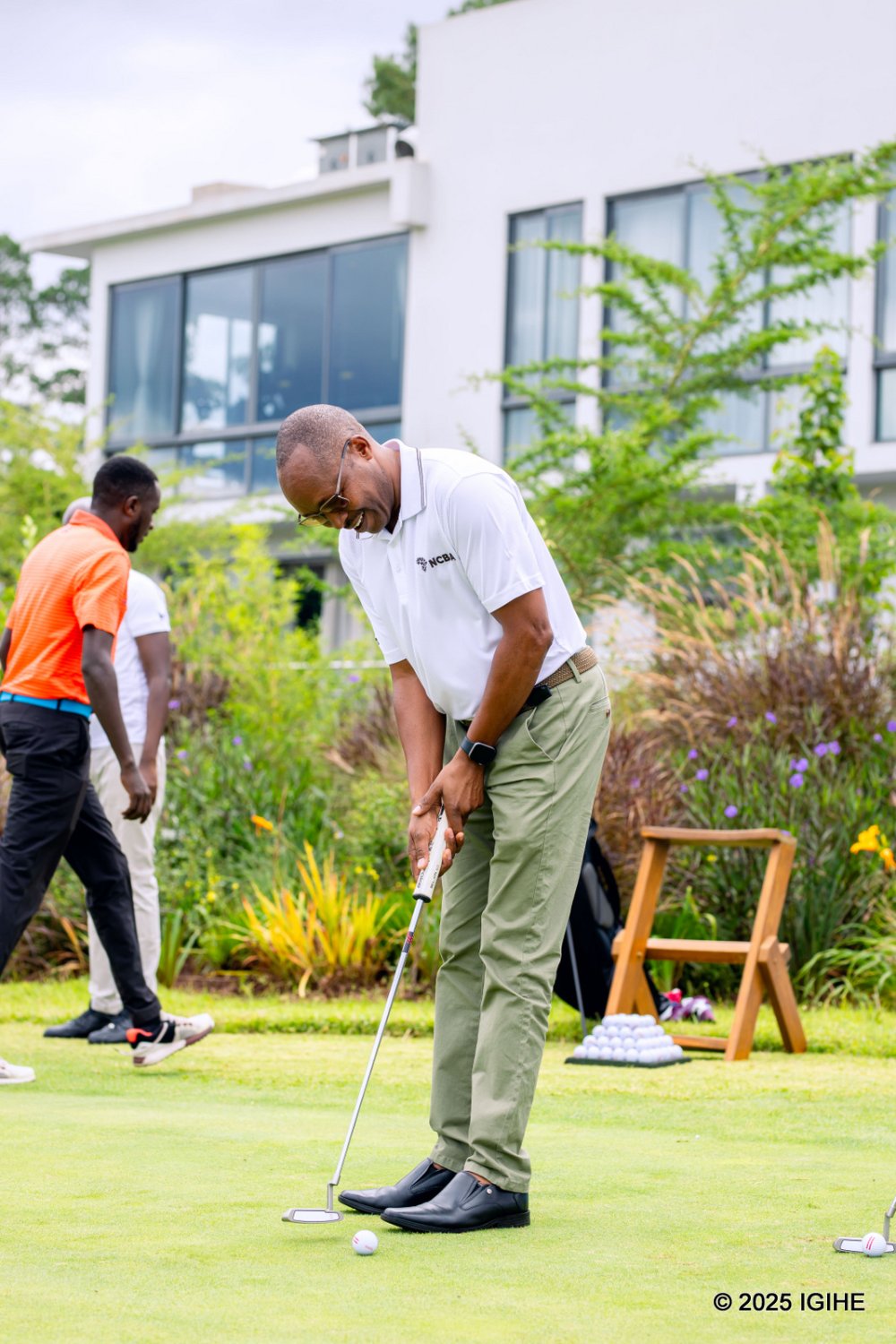 NCBA Group Managing Director, Maurice Toroitich, takes a swing at playing golf.