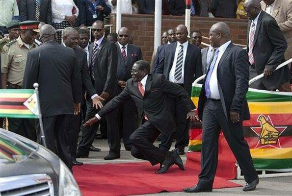 President Robert Mugabe takes a tumble on the red carpet