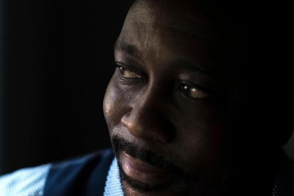 Air Force veteran Darryl Lewis poses for a portrait at his home, Thursday, Aug. 4, 2016, in Smyrna, Ga. Lewis filed a lawsuit in federal court in Washington saying he was illegally held and tortured by two top-ranking officials in Congo's government.