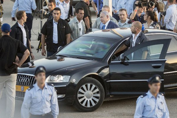 Israeli Prime Minister Benjamin Netanyahu (centre) gets in his armoured car as he leaves after a graduation ceremony of Israeli air force pilots at the Hatzerim base in the Negev desert, near the southern city of Beer Sheva, on June 30, 2016. Netanyahu is set to make his first trip as premier to Africa. 