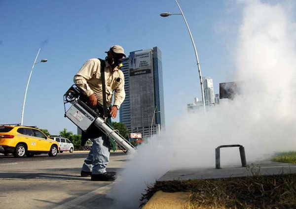 Health ministry workers fumigate against the Aedes aegypti mosquito, which transmits Zika virus, in downtown Panama City on February 2, 2016.
