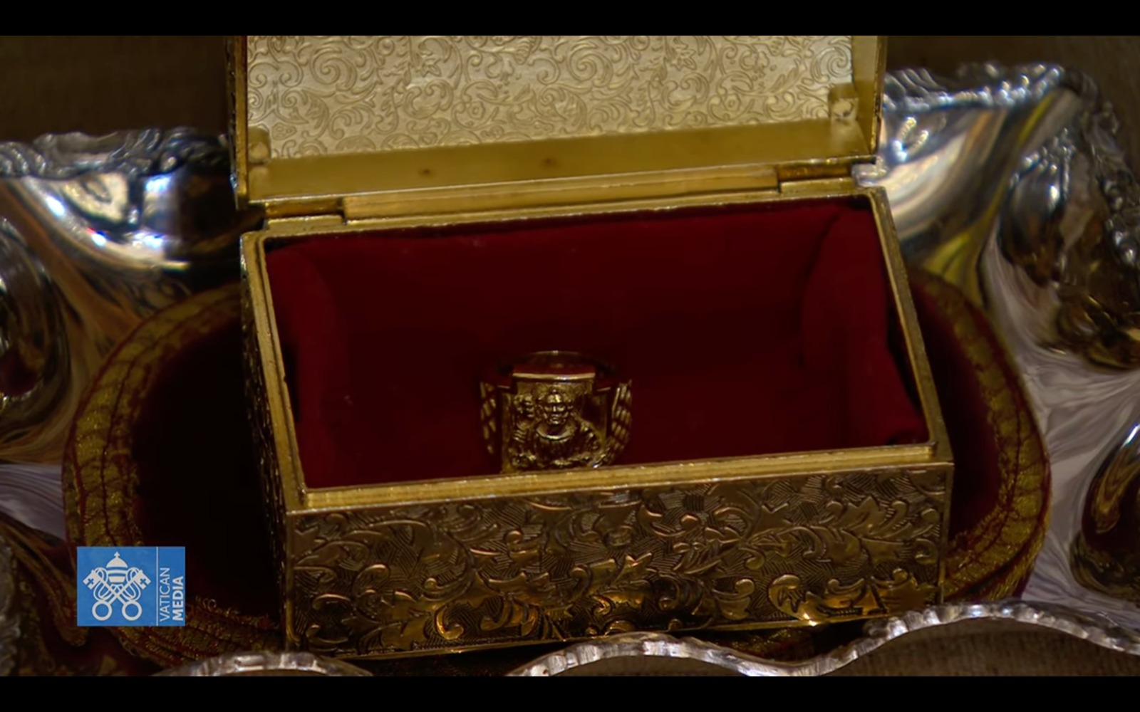 The Ring of the Fisherman inside an ornate, gold-embossed case lined with red velvet.